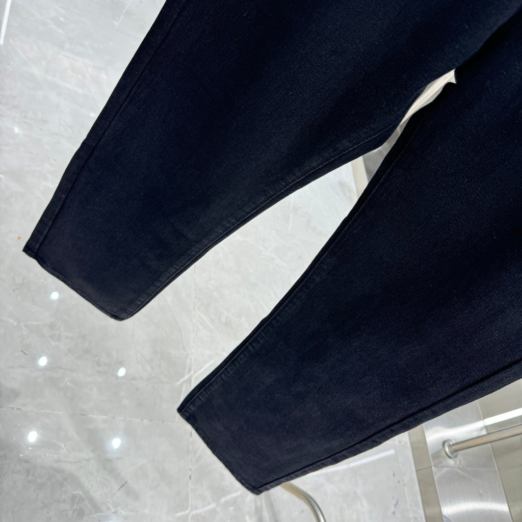 Dark denim pants with straight legs and folded hem