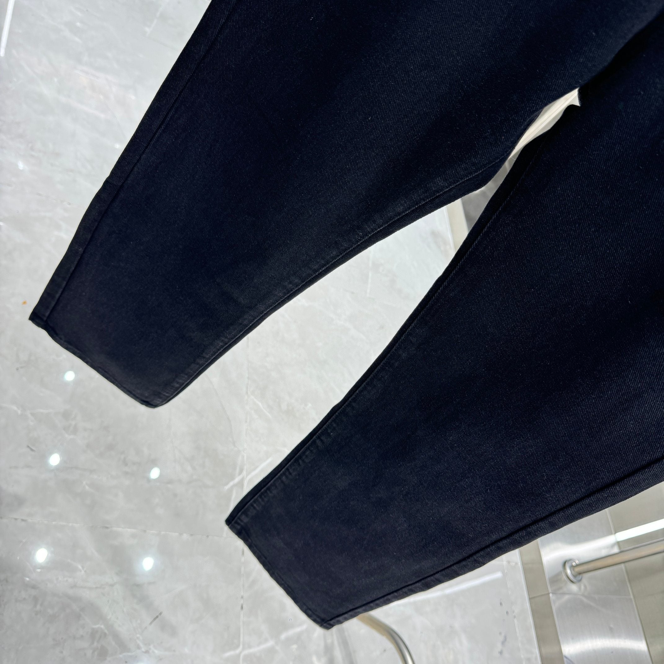 Dark denim pants with straight legs and folded hem