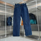 Blue denim Louis Vuitton pants on hanger, straight-leg fit with belt loops