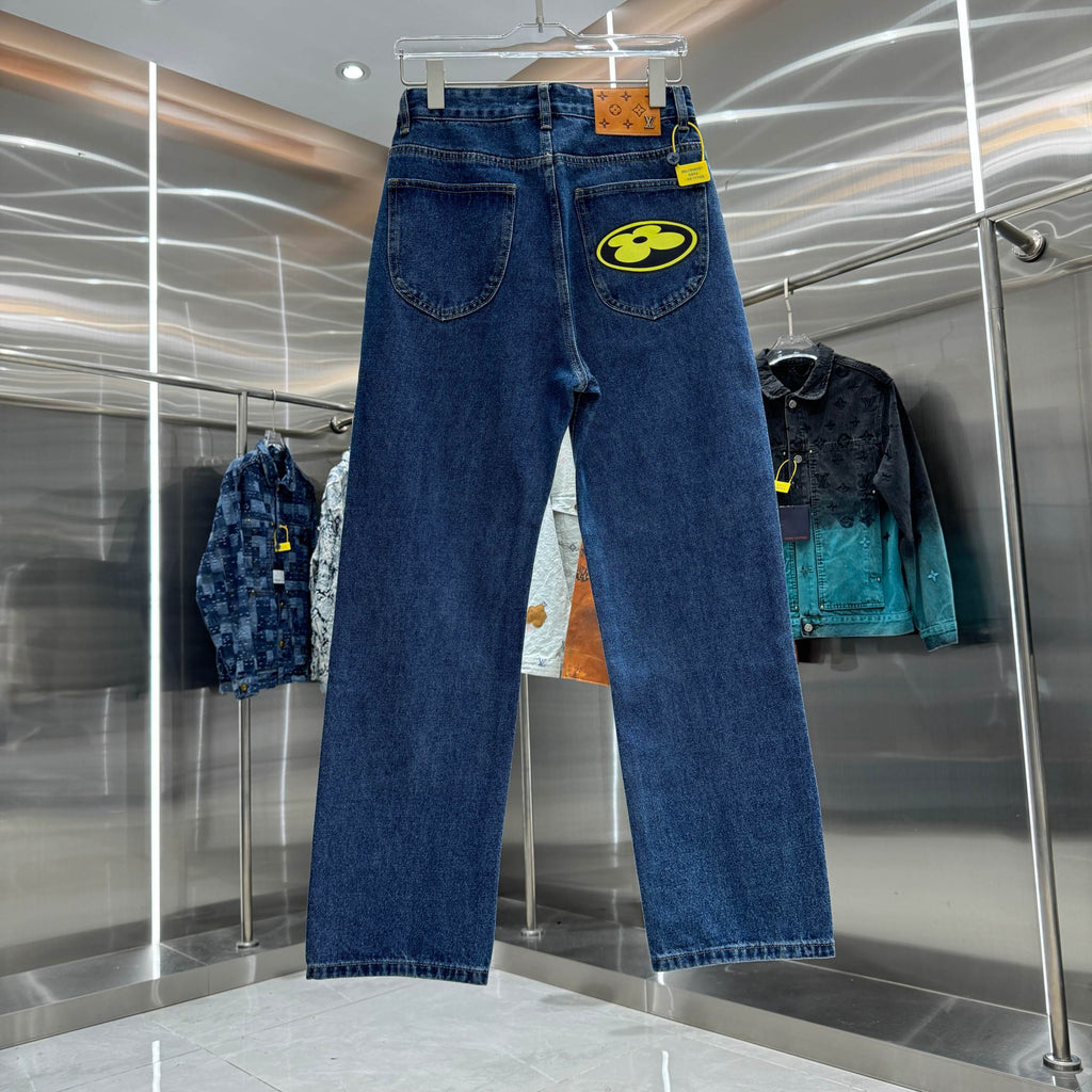 Blue denim Louis Vuitton pants on hanger, straight-leg fit with yellow logo patch