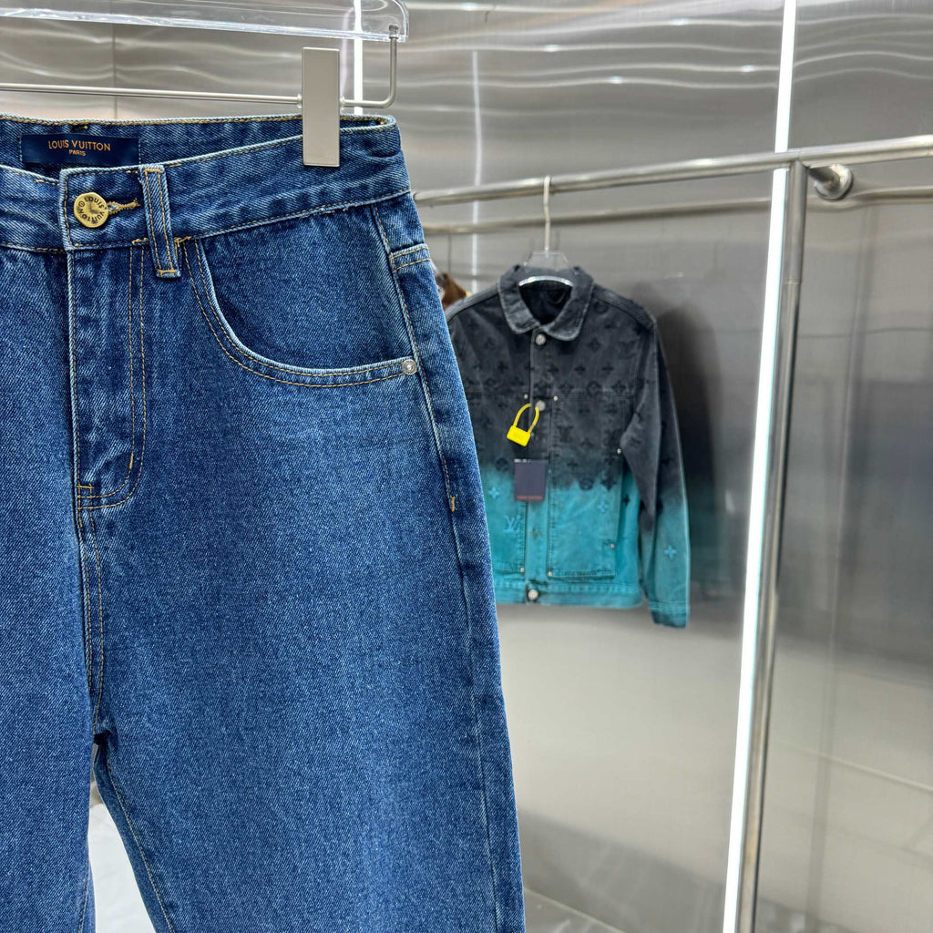 Blue denim Louis Vuitton pants side view, stitched pockets and gold button