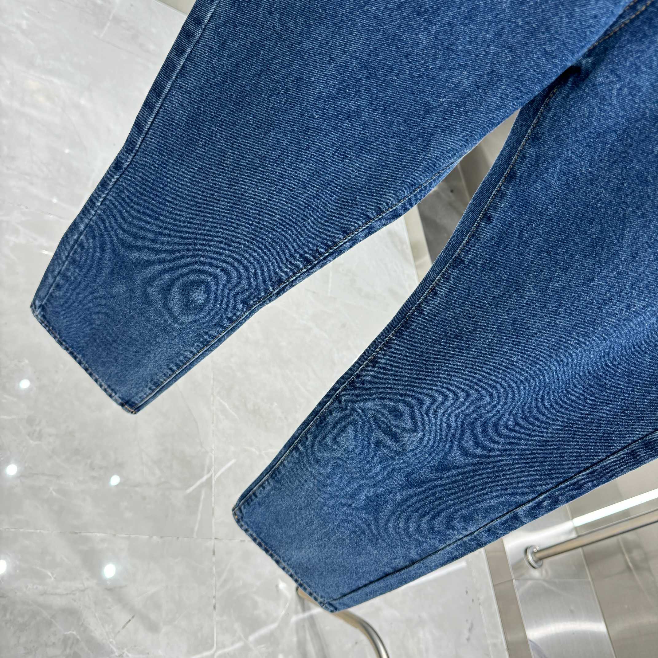 Blue denim Louis Vuitton pants hem detail, straight-leg cuffed bottoms