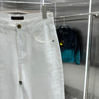 White denim pants with gold-tone button, curved front pocket, and belt loops