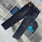 Dark denim jeans laid flat, showing front pockets and seams