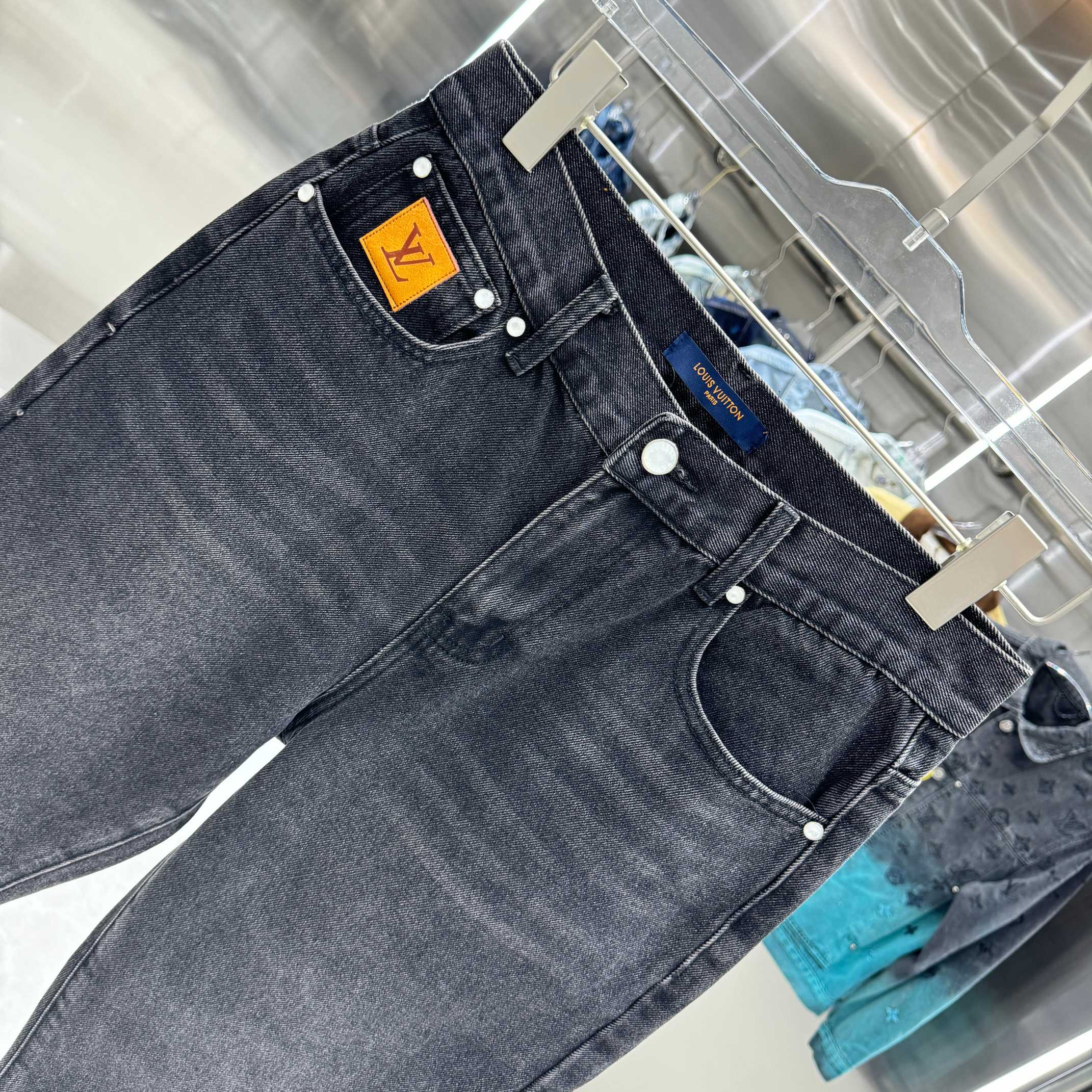 Dark denim jeans waistband patch with metal buttons and belt loops