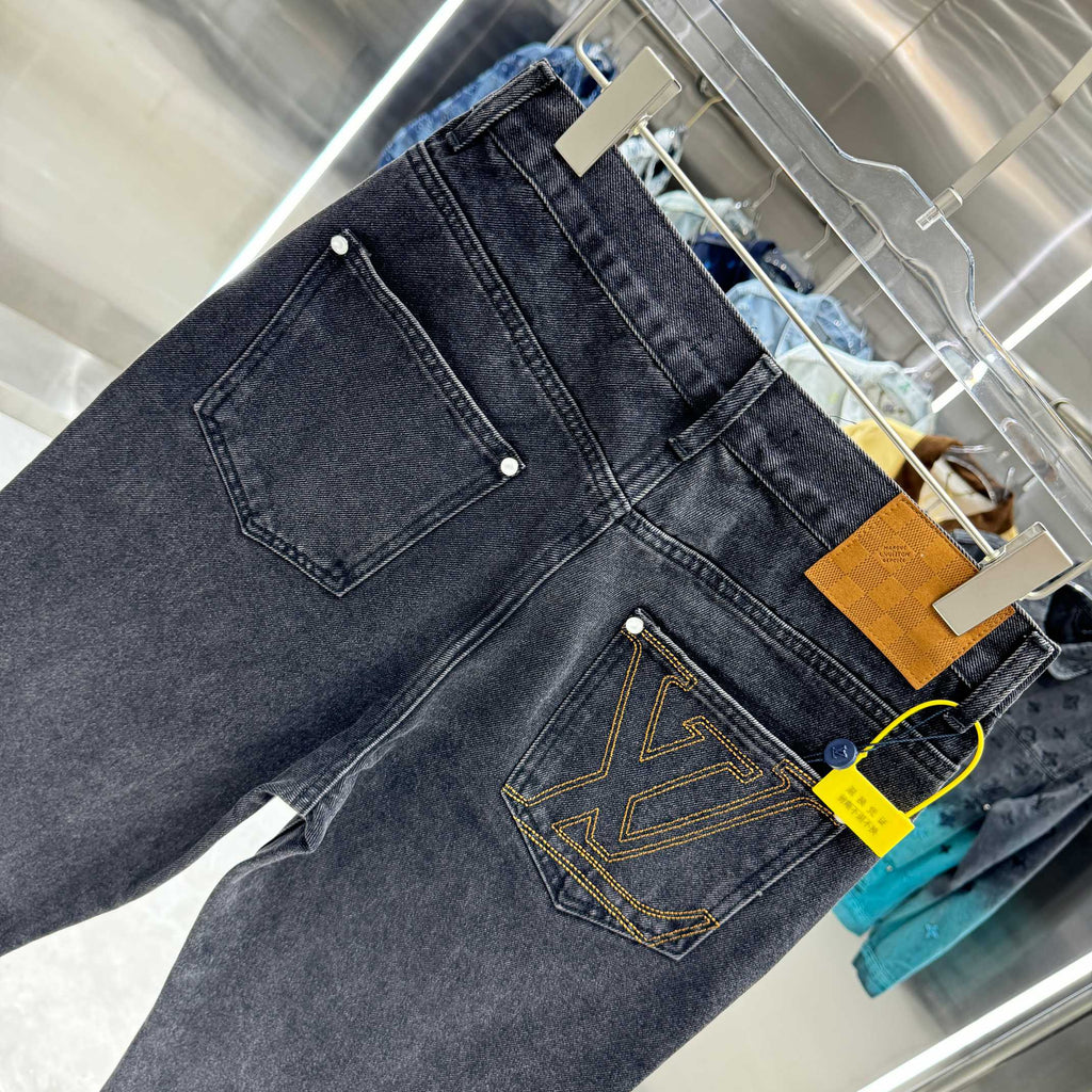 Dark denim jeans with front coin pocket and yellow emblem stitching