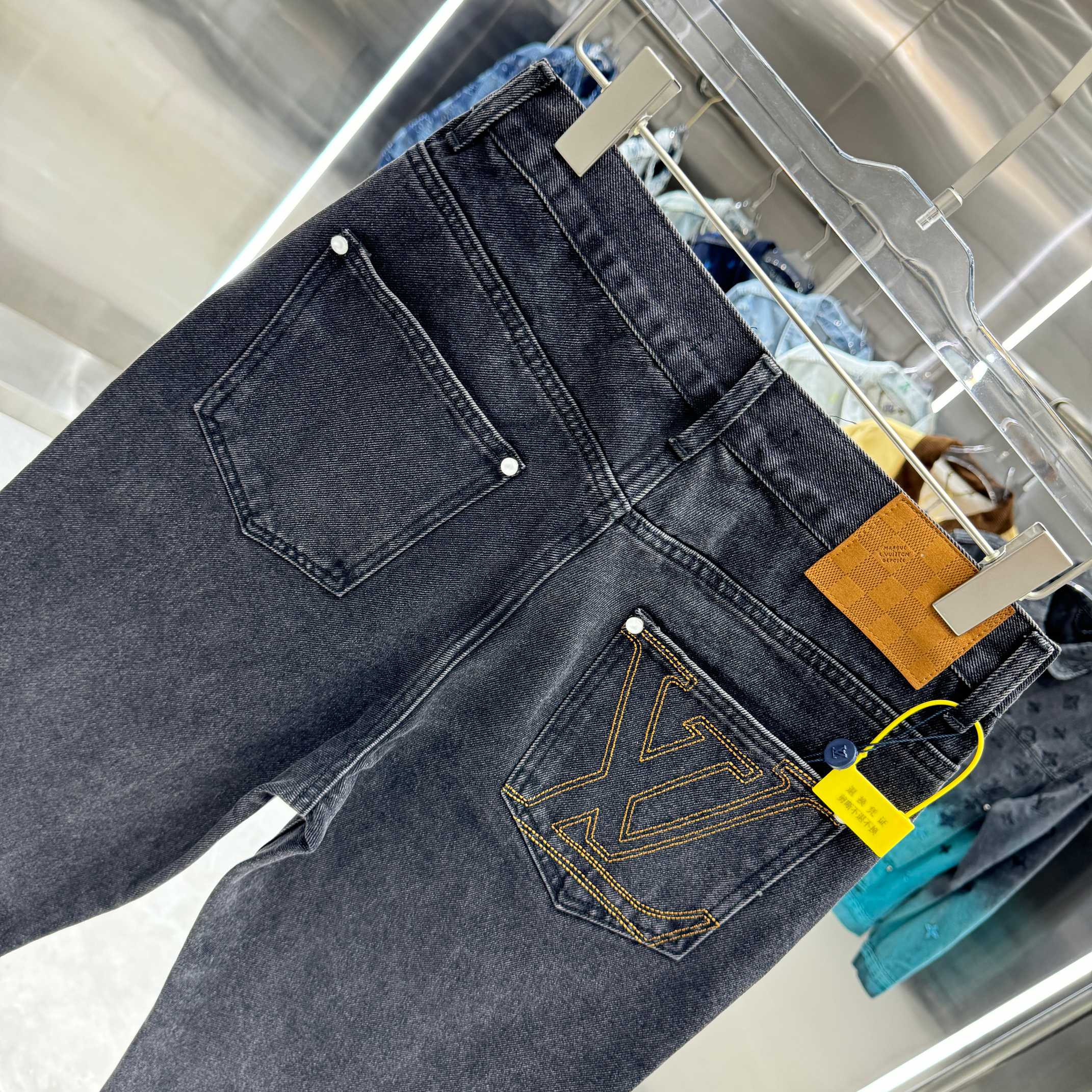 Dark denim jeans with front coin pocket and yellow emblem stitching