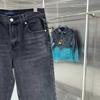 Dark denim jeans on hanger with front pocket and button closure