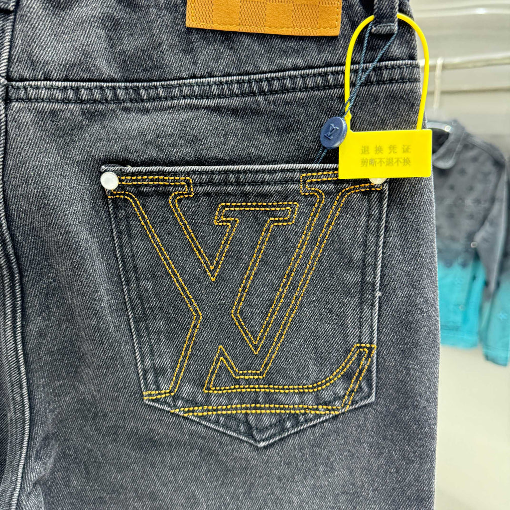 Dark denim coin pocket with yellow LV-style V emblem stitching