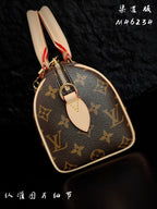 Louis Vuitton monogram handbag side view with zipper and leather strap loop