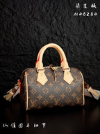 Louis Vuitton monogram handbag with tan handles and side shoulder straps