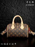 Louis Vuitton monogram handbag front view with tan leather handles and shoulder straps