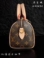 Louis Vuitton monogram top view with zipper track and tan leather pull tab