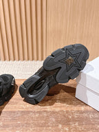 Black unisex sneaker outsole with star tread pattern, rubber grip sole
