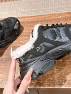Black unisex sneaker with white sherpa trim, textured laces, molded rubber sole