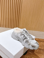 Silver metallic lace-up sneaker with faux-fur collar and star emblem, on white box