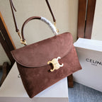 Celine handbag with flap, gold logo clasp, and white chain handle over dark brown leather