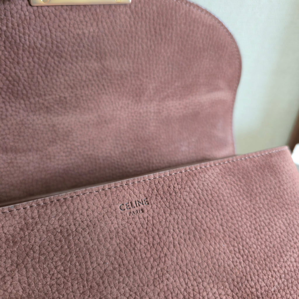 Celine handbag close-up showing textured leather and small gold "CELINE PARIS" stamp