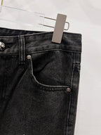Black denim pants with front pocket seam and metal button detail