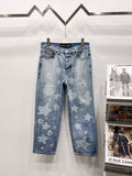 Light blue denim pants with star and heart print, five-pocket style and belt loops