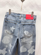 Light blue denim pants with star-and-heart print, back pockets and red logo label