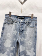 Light blue denim pants with star-and-heart print, front pockets and waistband