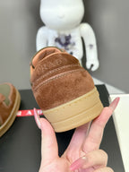 Unisex sneakers heel view in brown suede with light sole and contrasting side stripe