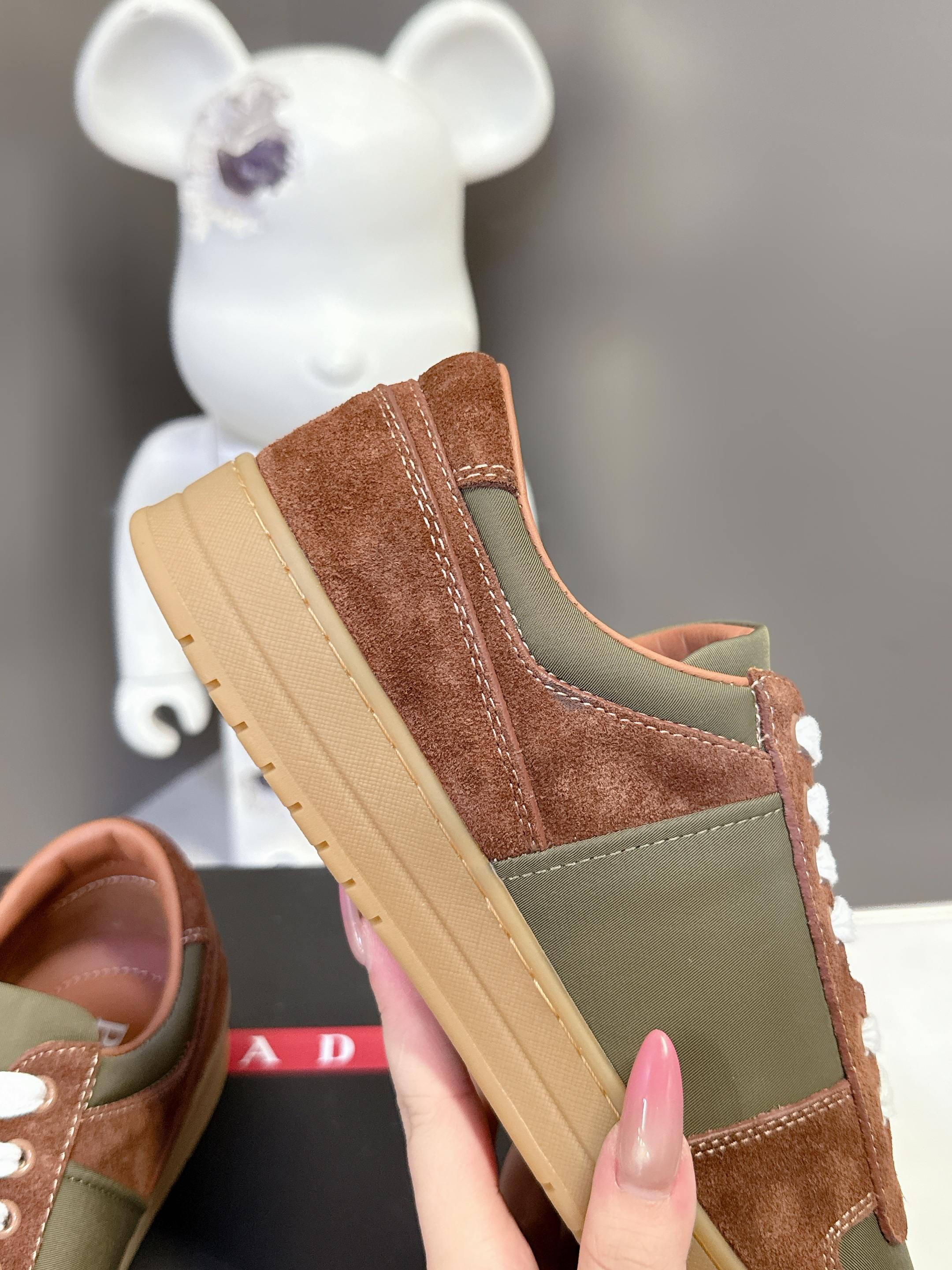 Unisex suede sneakers with brown upper, olive side panel, and light sole platform
