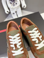 Unisex sneakers front view: brown and olive uppers with white laces and red brand tab