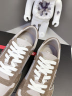 Front view of taupe sneakers with white laces and contrasting white/gray lining