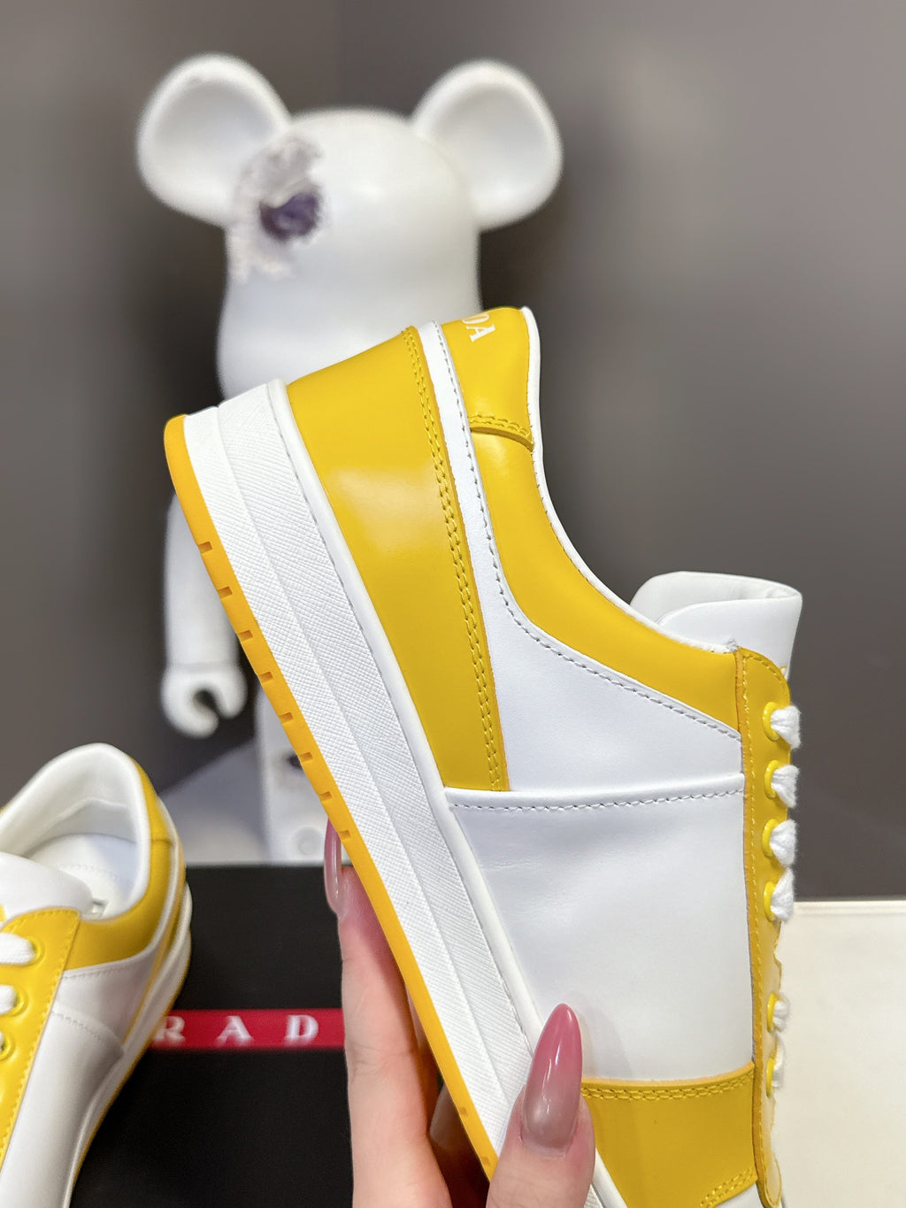 Prada unisex sneakers profile, white sidewall and yellow heel panel with thick sole