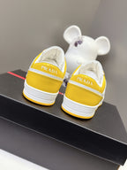 Prada unisex sneakers back view, yellow uppers with white heel and Prada branding