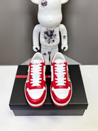Red and white low-top sneakers on a black box with white laces