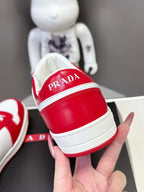 Red and white sneaker heel with PRADA lettering