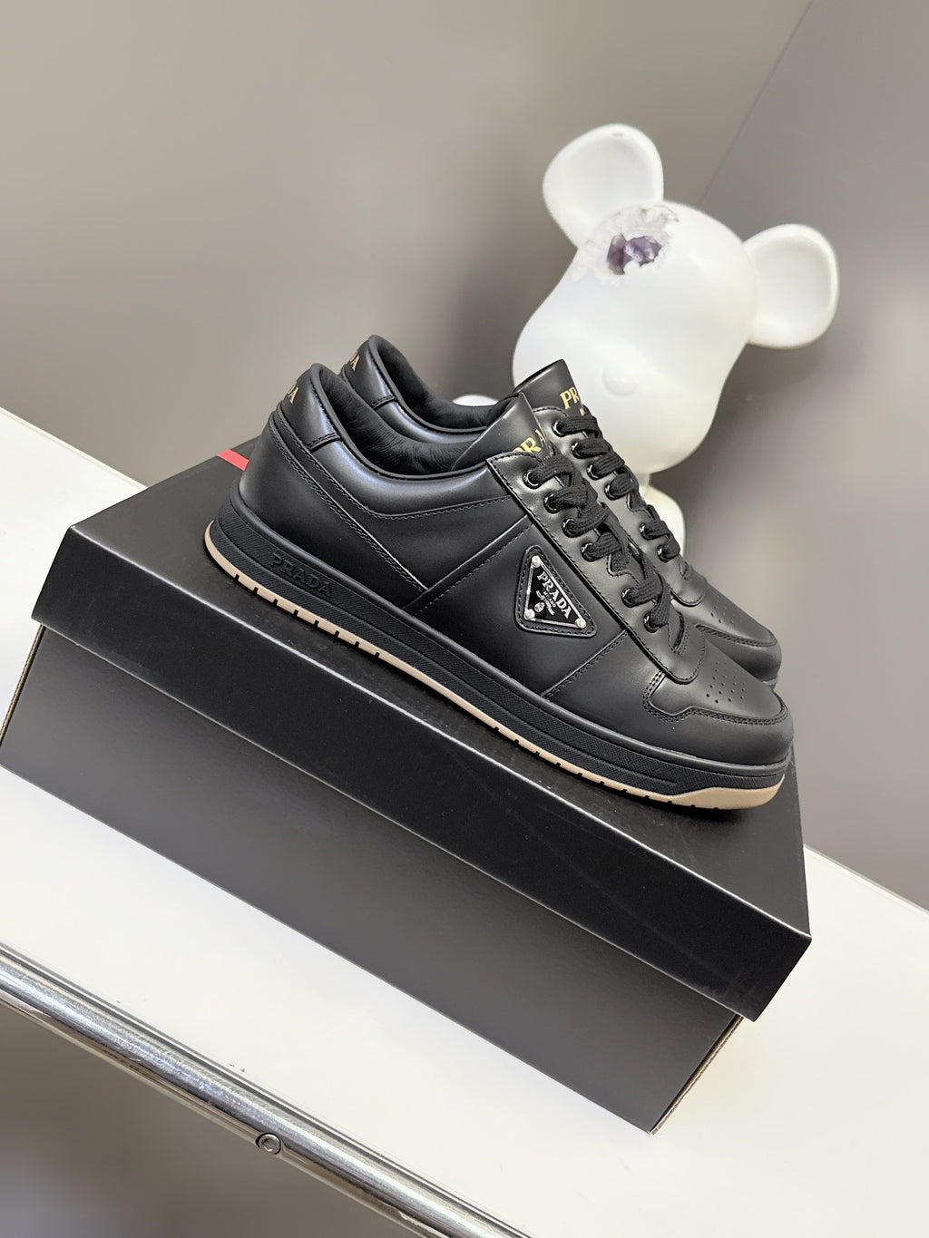 Prada black lace-up sneakers with logo patch and textured rubber sole