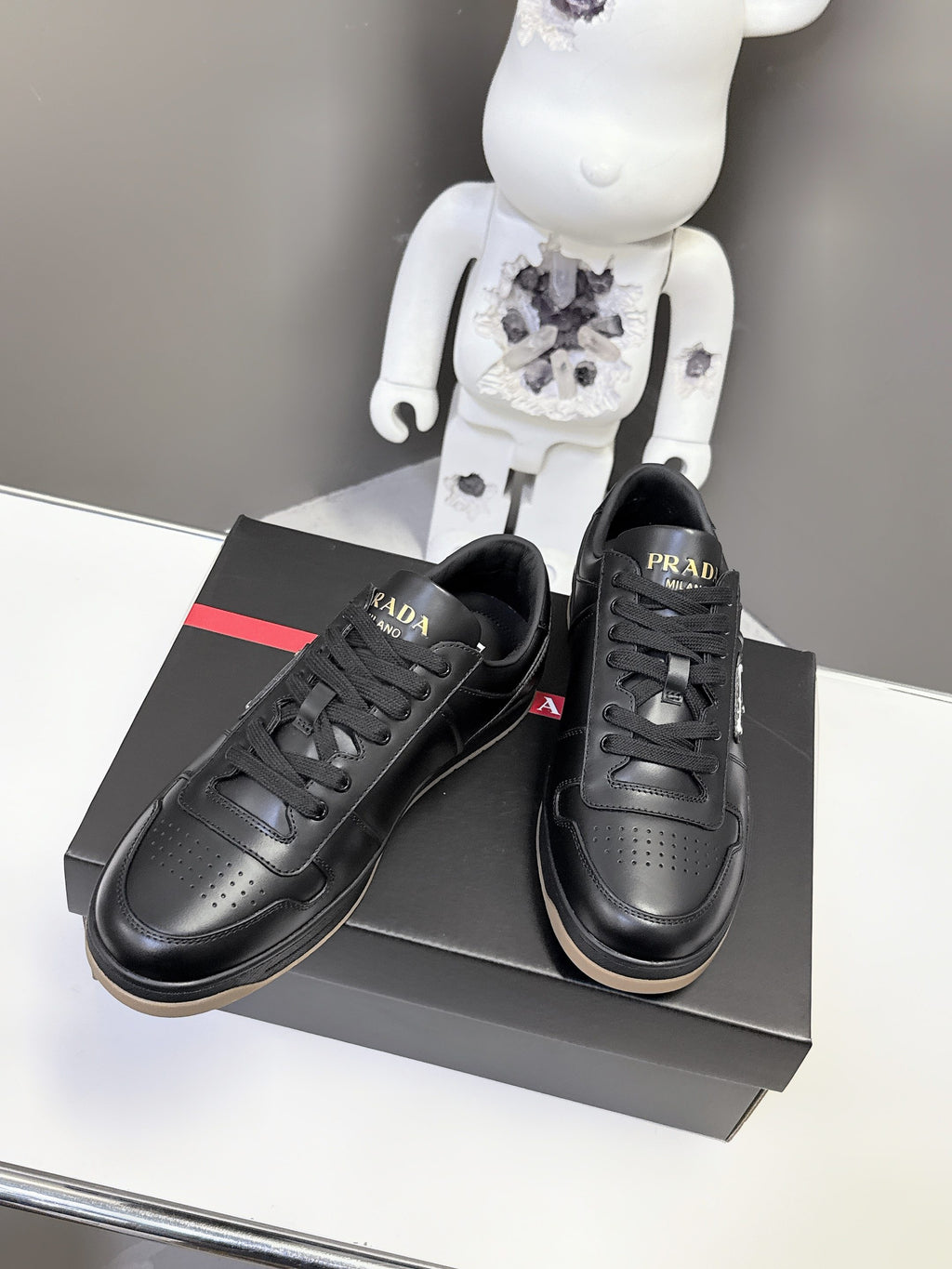 Prada black leather lace-up sneakers with contrast sole edge and logo details