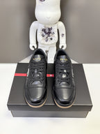 Prada black lace-up sneakers on box, side panels and PRADA tongue branding visible