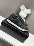 Black Prada unisex low-top sneakers with lace-up front and white rubber sole