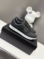 Black Prada unisex low-top sneakers with lace-up front and white rubber sole