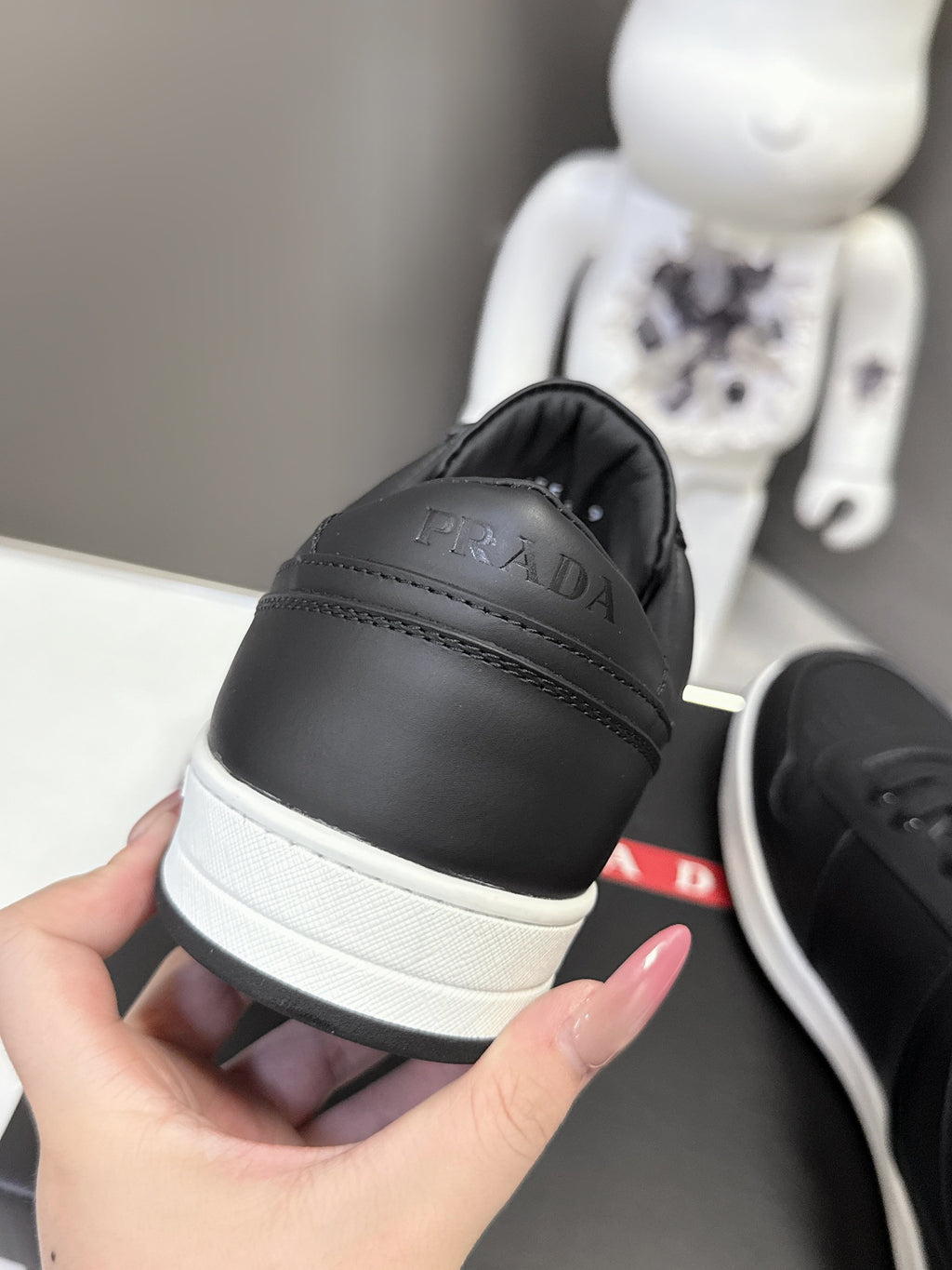 Black Prada unisex sneakers showing cushioned heel with white rubber sole