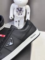 Black Prada unisex low-top sneaker with side logo patch and white rubber sole