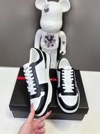 Prada unisex sneakers, hand-held pair with white laces and black side stripe