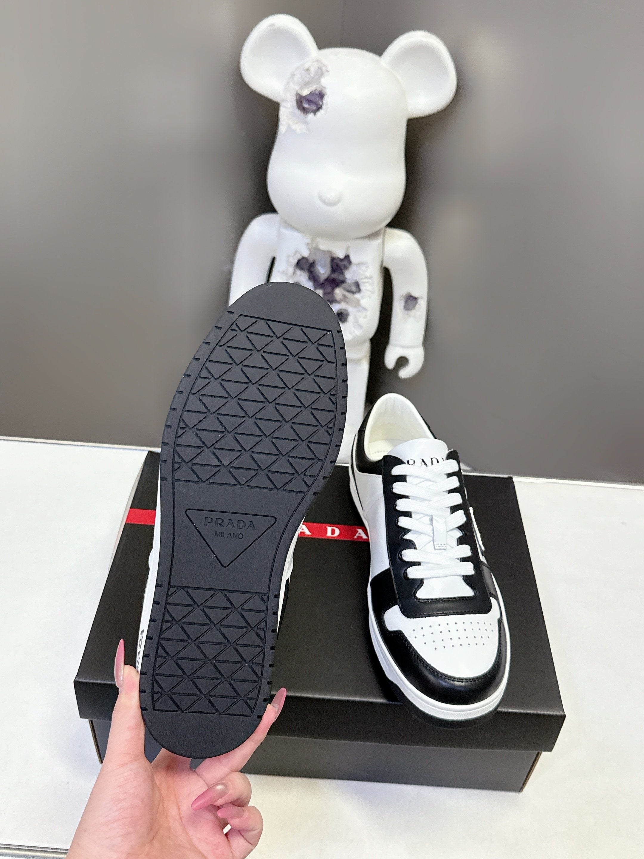 Prada unisex sneakers outsole view, textured black rubber sole