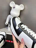 Prada unisex sneakers side profile, white panels with black side band and lace trim