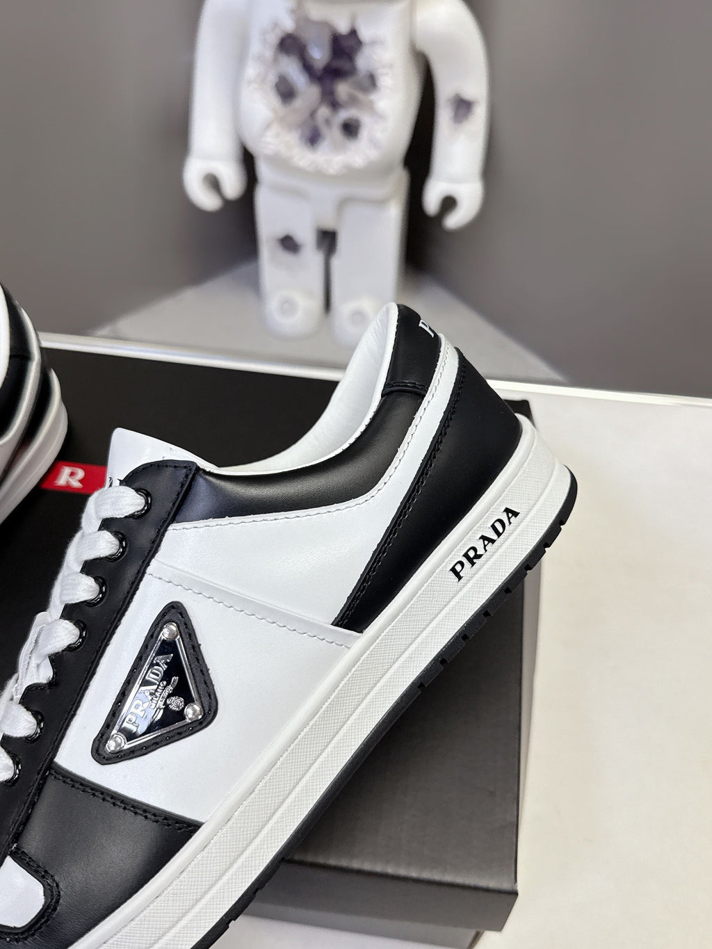 Prada unisex sneakers, white and black leather with triangular logo badge on side