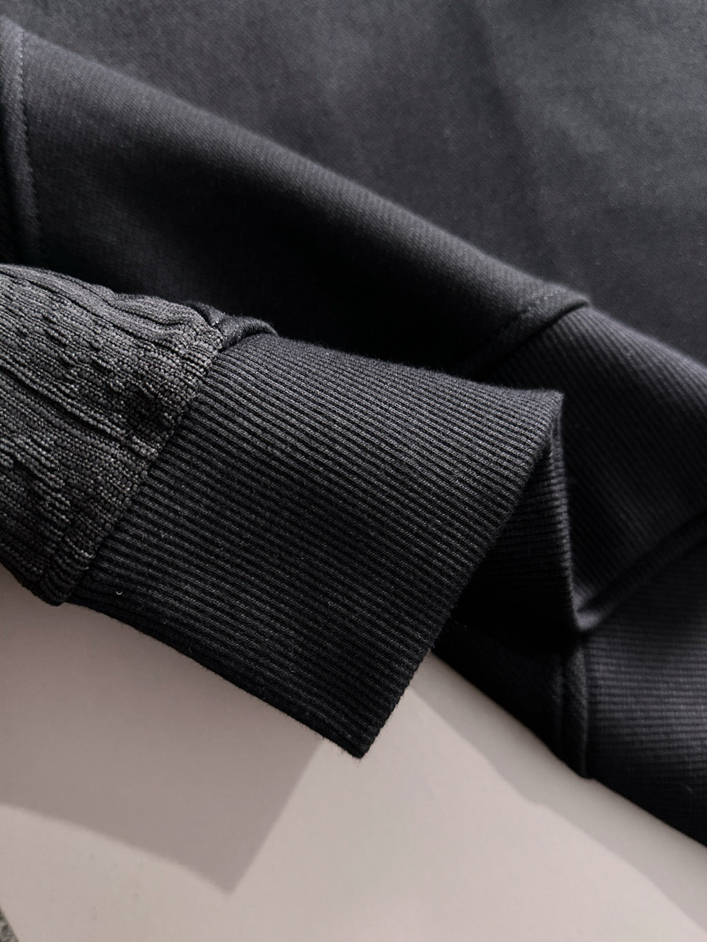 Fendi black sweatshirt sleeve cuff close-up with ribbed knit trim