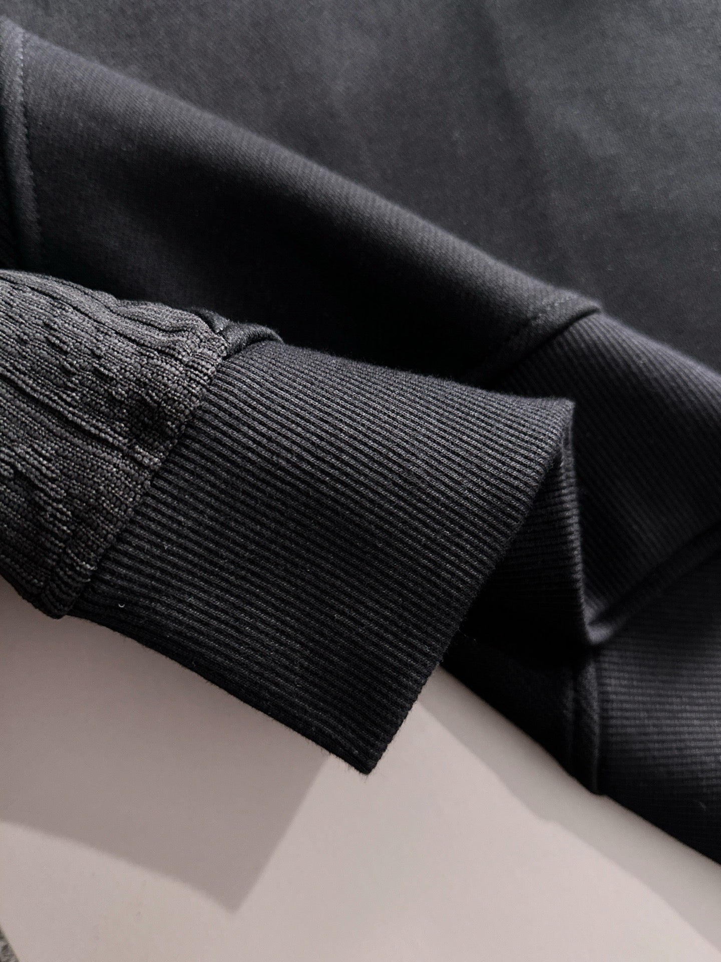 Fendi black sweatshirt sleeve cuff close-up with ribbed knit trim