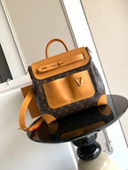 Louis Vuitton monogram handbag with tan leather handles and gold hardware