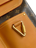 Louis Vuitton monogram bag close-up of tan leather flap and gold lock clasp