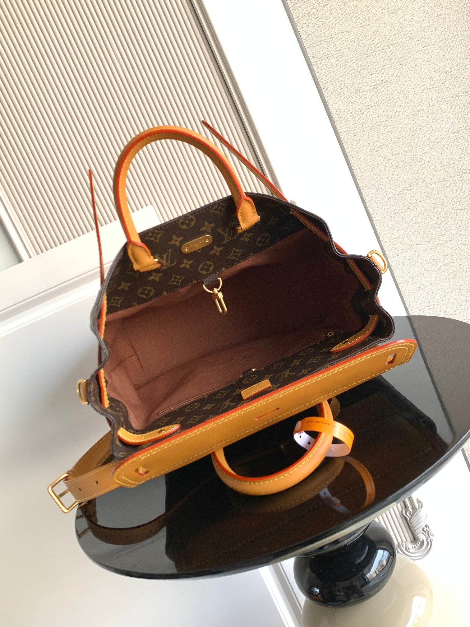 Louis Vuitton men's bag open view, tan interior, top handle and shoulder strap